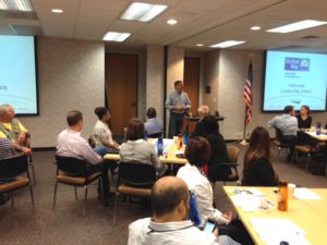 Pete Tosh (standing, center) speaks during last week's ServiceMaster leadership breakfast about the importance of supporting our Mid-South community.