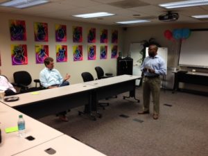 TruGreen CEO David Alexander (seated) discusses the company's campaign plans with Patrick Alexander (standing).