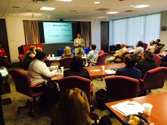 Dr. Robinson (center) talks to visiting agency representatives about the importance of establishing good credit for people all throughout the Mid-South.