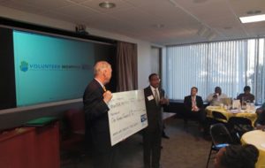 David Williams, President/CEO of Leadership Memphis (left) and Dr. Kenneth S. Robinson M.D., President/CEO of United Way of the Mid-South, present United Way's $100,000 Catalyst Fund investment in Volunteer Memphis during a meeting of local leaders at United Way headquarters earlier today.