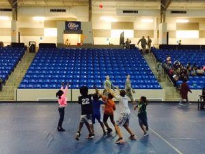 U.S Soldier, back center, playing touch football with some of the children, whose parents received free medical services.